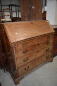 A Georgian bureau chest of four drawers in bleached mahogany with column sides