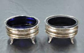 A pair of George V silver salts, of moulded oval form shaped rim and fluted cabriole type legs, each