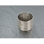 A large Edwardian silver napkin ring, of circular form with repeating geometric decoration centred