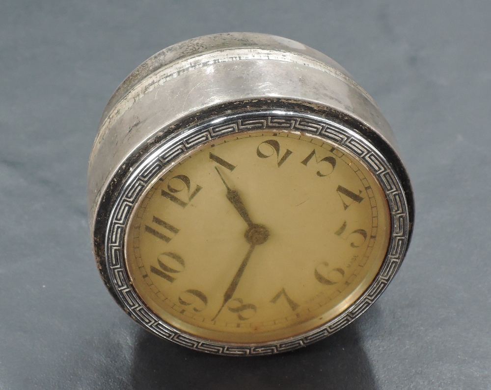 A Silver mounted 1930's clock, with Meandros border, bearing lion passant...