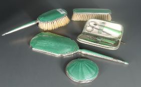 A George VI guilloche enamelled silver backed three-piece dressing table set, comprising hand