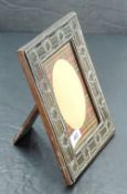An Edwardian silver mounted oak photograph frame, of rectangular form, embossed with repeating