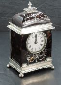 An Edwardian silver and tortoiseshell mantel clock, the domed top with turned and gadrooned finial