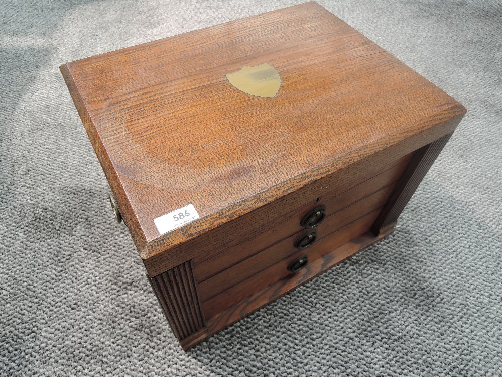 A Walker & Hall oak cased canteen of cutlery, of rectangular form, the hinged top with central