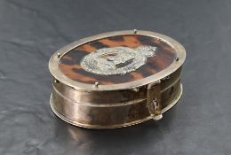 An unusual silver and tortoiseshell box, of hinged oval form, the cover with applied memorial plaque