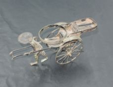 A 19th century Chinese white metal condiment stand, formed as a Rickshaw and driver, Chinese
