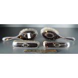 A George V silver six-piece silver and tortoiseshell dressing table set, comprising a hand mirror,