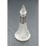 An Edwardian cut glass perfume bottle of conical form having cut glass stopper and moulded silver
