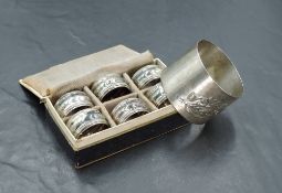 A boxed set of six small German white metal napkin rings, of circular moulded form with engraved