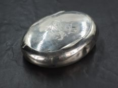 An Edwardian silver snuff box, of oval form curved for the gentleman's pocket, the hinged cover with