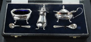 An Elizabeth II cased silver condiment set, comprising salt, pepperette and mustard, with two