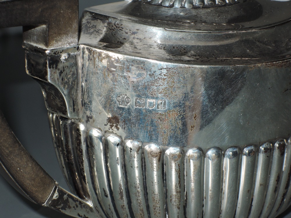 An Edwardian silver three piece teaset, of half fluted oval form with angular handles, marks for - Image 2 of 4