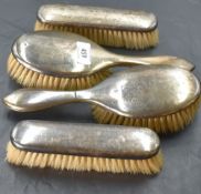 A George V silver mounted four-piece brush set, of plain traditional design, marks for Birmingham