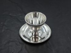A George VI silver egg cup, of traditional design with fluted rim and dished circular base, marks