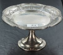 An Edwardian silver tazza, of lobed circular form with reeded rim detail enclosing pierced swag