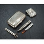 A silver cigarette case, silver vesta, silver cased and mounted amber charoot, sold along with a