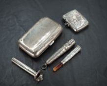 A silver cigarette case, silver vesta, silver cased and mounted amber charoot, sold along with a