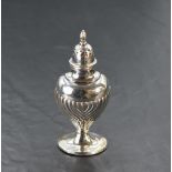 An Edwardian silver pepperette, of moulded and half fluted form with pierced and domed cover with