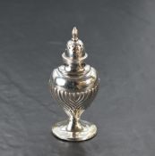 An Edwardian silver pepperette, of moulded and half fluted form with pierced and domed cover with