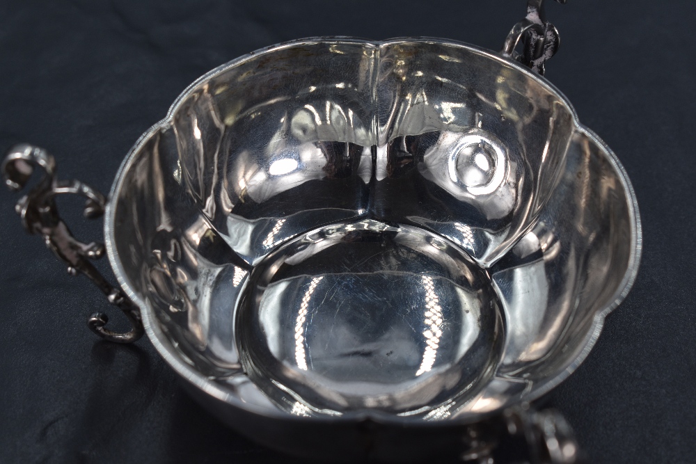 An Edwardian silver bowl, of lobed circular form with three applied scrolling handles extending as - Image 2 of 2