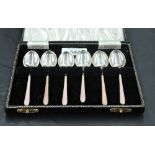 A 1950's cased set of enamelled silver coffee spoons, decorated with engine turned handles with