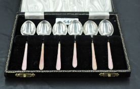 A 1950's cased set of enamelled silver coffee spoons, decorated with engine turned handles with