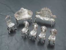 A group of seven miniature imported Hanau white metal salon furniture items, comprising two