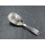 An early 19th century Irish Silver caddy spoon, fiddle pattern with shaped and fluted oval bowl,