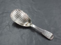 An early 19th century Irish Silver caddy spoon, fiddle pattern with shaped and fluted oval bowl,