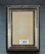 A modern silver mounted photograph frame, of rectangular form with moulded decoration, marks for