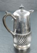 A George VI silver hot water pot, having a domed and fluted hinged cover with ebony finial over