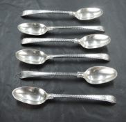 Six Georgian silver teaspoons of fiddle back form having cut edges and crest to terminals, bottom