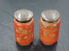 A pair of late 19th/early 20th century silver topped Satsuma pottery pepperettes, the pierced