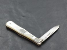 A small George V silver bladed and Mother-of-Pearl handled fruit knife, of traditional design, marks