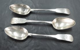 Three Queen Anne silver dessert spoons of fiddle back pattern having monogram to terminals and