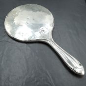 A George V silver hand mirror, of traditional form with muted stylised detail, marks for