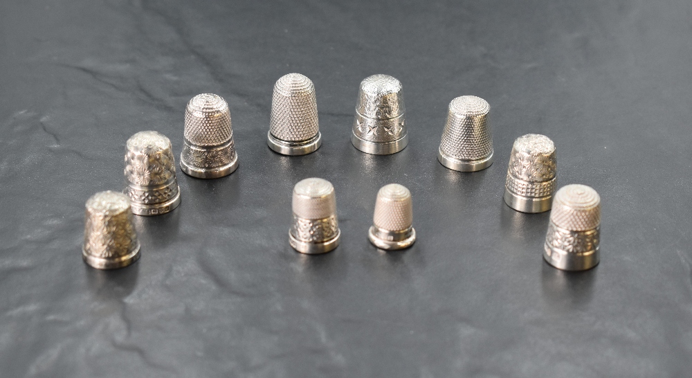 Nine HM silver thimbles of various dates and forms including Charles Horner and a DORCAS white metal