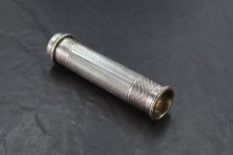 A 1930's silver torch/flashlight, of cylindrical form with engine-turned surface and scrolled rims