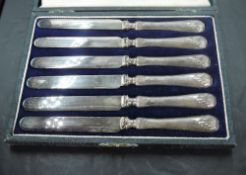 A cased set of six George V silver-handled butter knives, marks for Sheffield 1919, maker R F Mosley