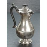 An Edwardian silver hotwater pot, of baluster form with domed finial topped cover over s shallow