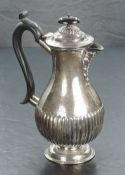 An Edwardian silver hotwater pot, of baluster form with domed finial topped cover over s shallow