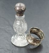 A silver topped cut-glass scent bottle, of baluster form with flared base 12cm sold along with a