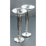 A pair of George V silver trumpet form spill vases, having flared rims over a moulded collar and