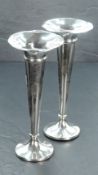 A pair of George V silver trumpet form spill vases, having flared rims over a moulded collar and