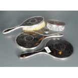 A George V silver and tortoiseshell six-piece dressing table set, comprising two hair brushes,