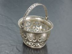 A Dutch white metal basket, of oval form with pierced over handle and body with beaded rims, Dutch