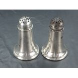 A pair of American Sterling pepperettes, with pierced domed covers of the tapering cylindrical