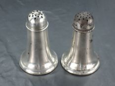 A pair of American Sterling pepperettes, with pierced domed covers of the tapering cylindrical