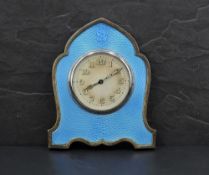 A George V silver & guilloche enamel clock, of shaped lancet form with blue enamelled engine