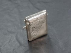 A George V silver vesta case, of traditional form with scrolled engraving, marks for Birmingham